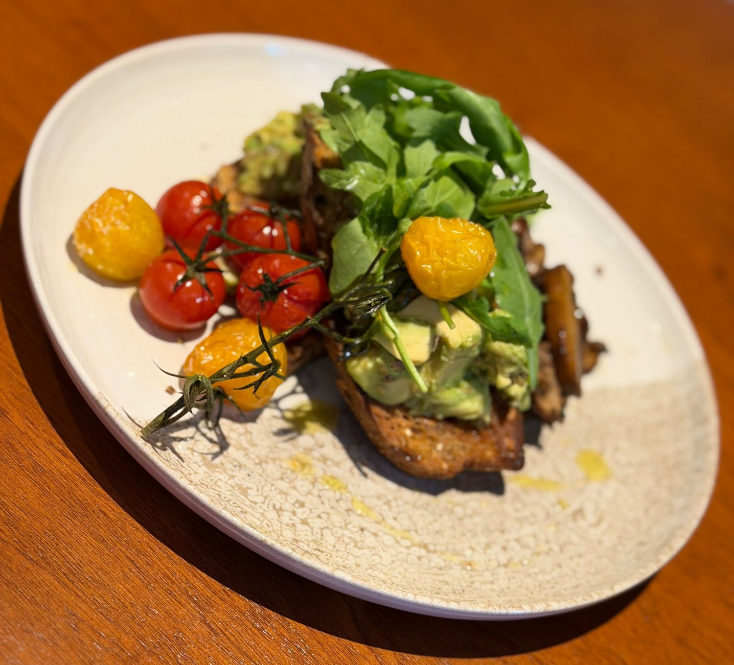 Avocado toast with roasted tomatoes at Cosy Cafe and Kitchen