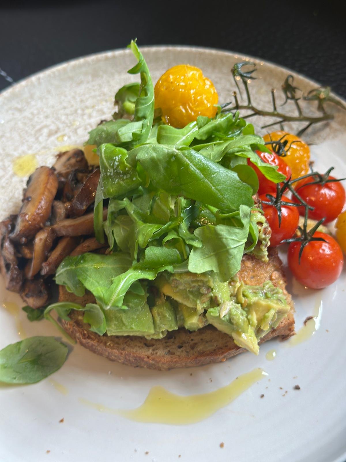 Avocado toast with roasted tomatoes at Cosy Cafe and Kitchen