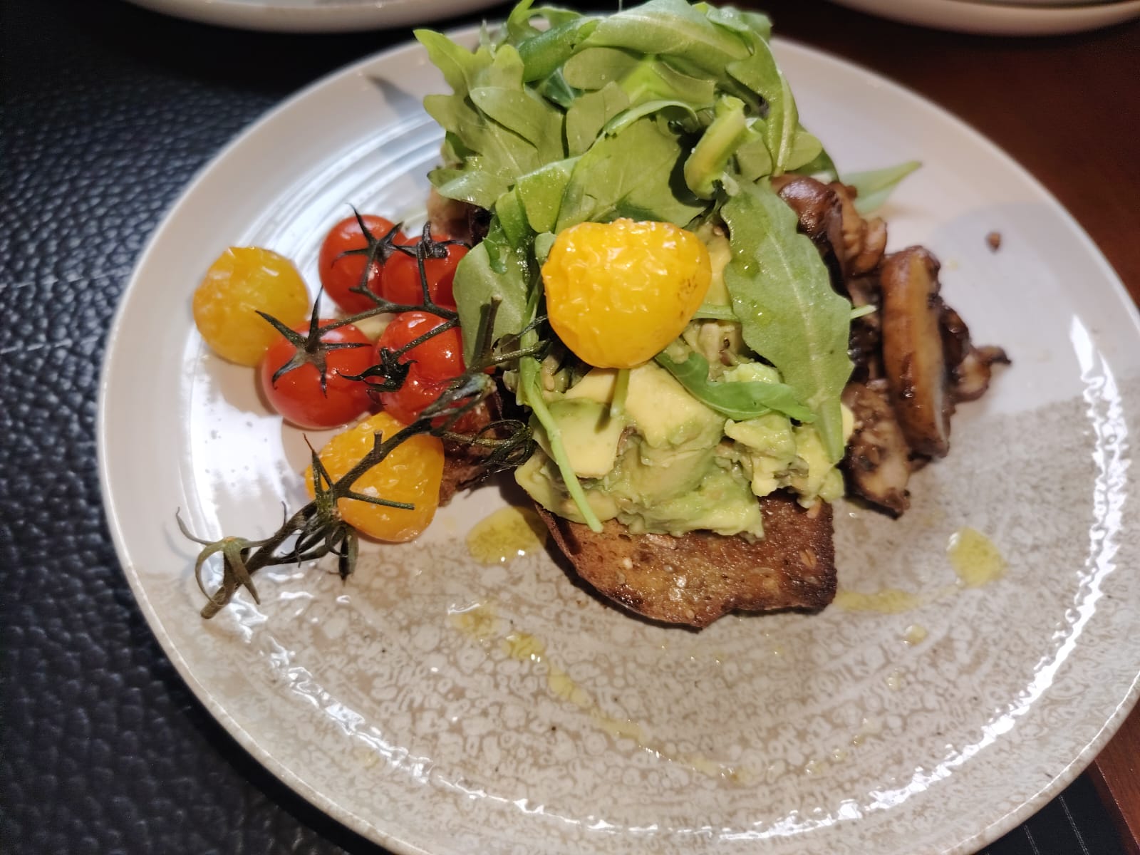 Avocado toast with mushrooms and roasted tomatoes at Cosy Cafe and Kitchen